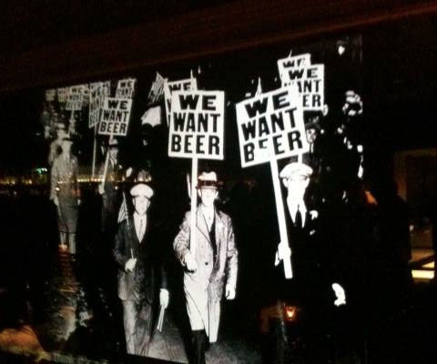 One of the Prohibition era posters displayed on screens around the bar.