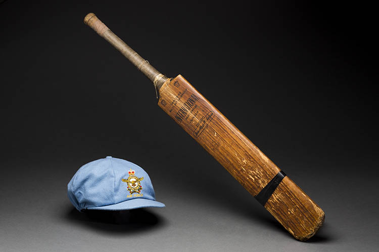 Catherine McGregor's objects: the first adult cricket bat her father gave her and her first cap playing for the women's Air Force cricket team