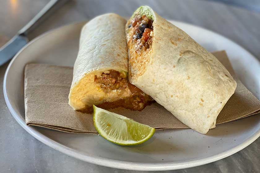 Breakfast Burritos with free-range eggs, chorizo, black beans, guacamole, tomato salsa, cheese and sour cream.