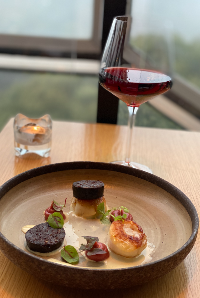 Butter-seared scallops, with rhubarb purée, English black pudding, and alpine apple cider butter